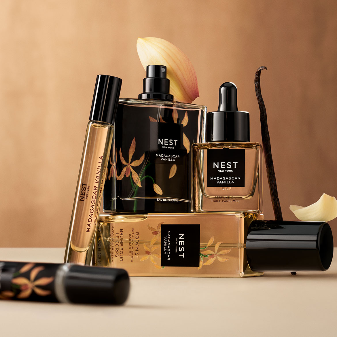Nest New York Madagascar Vanilla collection includes perfume oil, eau de parfum, and body mist, all in sleek black and gold packaging with vanilla flower designs.