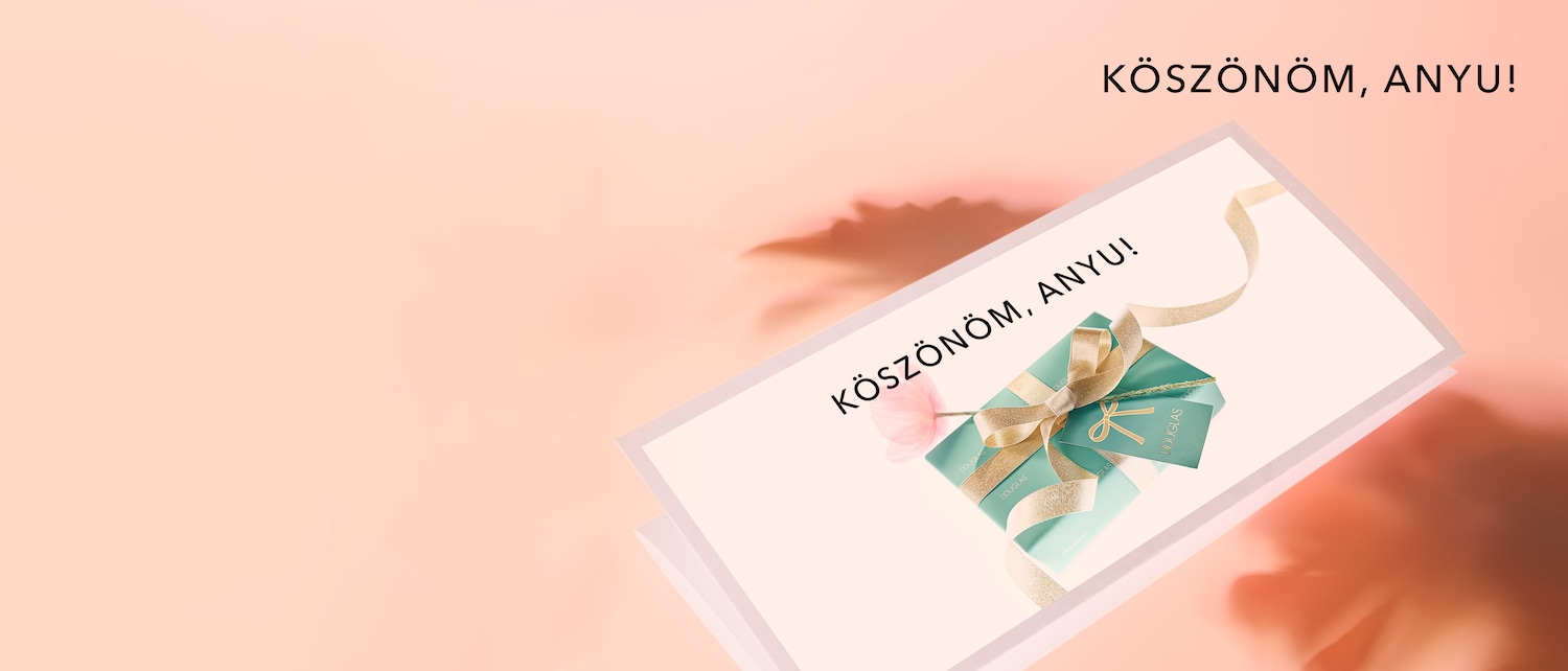 A rózsaszín háttér előtt egy Douglas ajándékcsomag látható, arany szalaggal átkötve, a "KÖSZÖNÖM, ANYU!" felirattal.